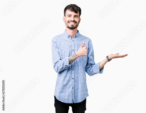 Young handsome business man over isolated background Showing palm hand and doing ok gesture with thumbs up, smiling happy and cheerful