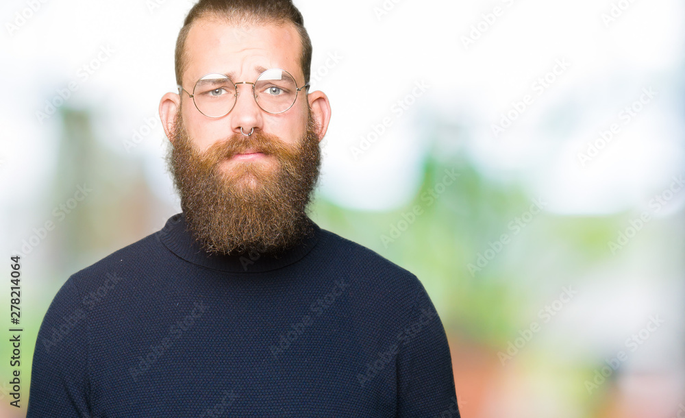 Young blond man wearing glasses and turtleneck sweater depressed and worry for distress, crying angry and afraid. Sad expression. Young blond man wearing glasses and turtleneck sweater depressed and worry for distress, crying angry and afraid. Sad expression.