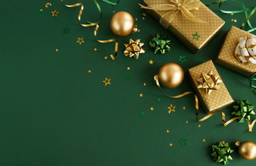 christmas or new year frame decorations in gold colors on dark green color background with empty copy space for text. holiday and celebration concept for postcard or invitation. top view 