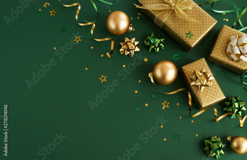 christmas or new year frame decorations in gold colors on dark green color ba...