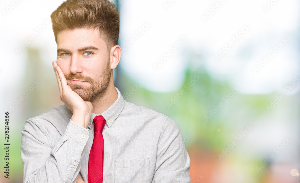 Young handsome business man thinking looking tired and bored with depression problems with crossed arms. Young handsome business man thinking looking tired and bored with depression problems with crossed arms.