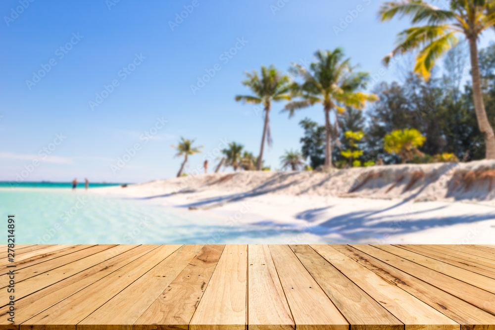 wood table background of free space for decoration and summer landscape.Wood table with blurred sea and coconut tree background.
