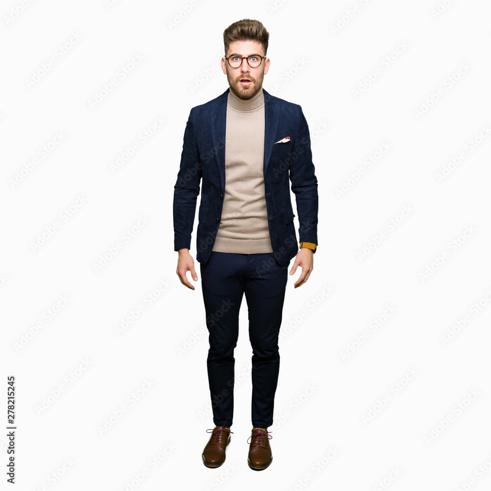 Young handsome business man wearing glasses afraid and shocked with surprise expression, fear and excited face. Young handsome business man wearing glasses afraid and shocked with surprise expression, fear and excited face.