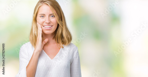 Beautiful young elegant woman over isolated background touching mouth with hand with painful expression because of toothache or dental illness on teeth. Dentist concept.