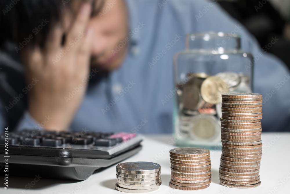 Asian man in blue shirt are stressed about money in the room. Asian man in blue shirt are stressed about money in the room.