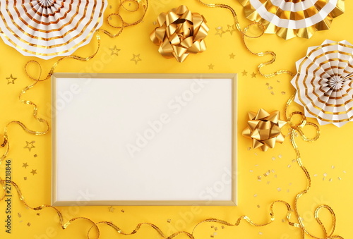 christmas or new year frame decorations and frame in gold colors on yellow  b...