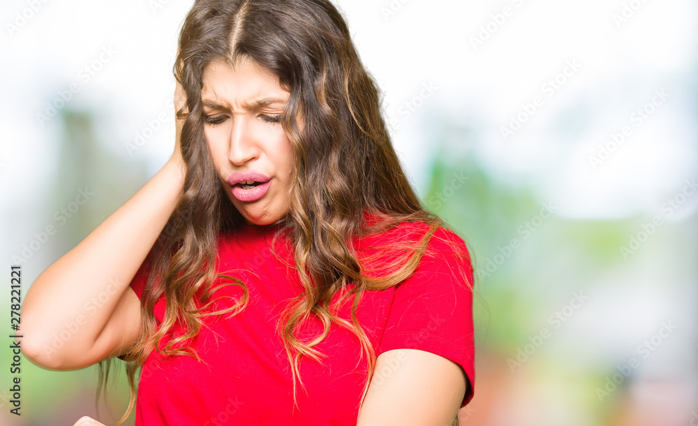 Young beautiful woman wearing casual t-shirt Looking at the watch time worried, afraid of getting late