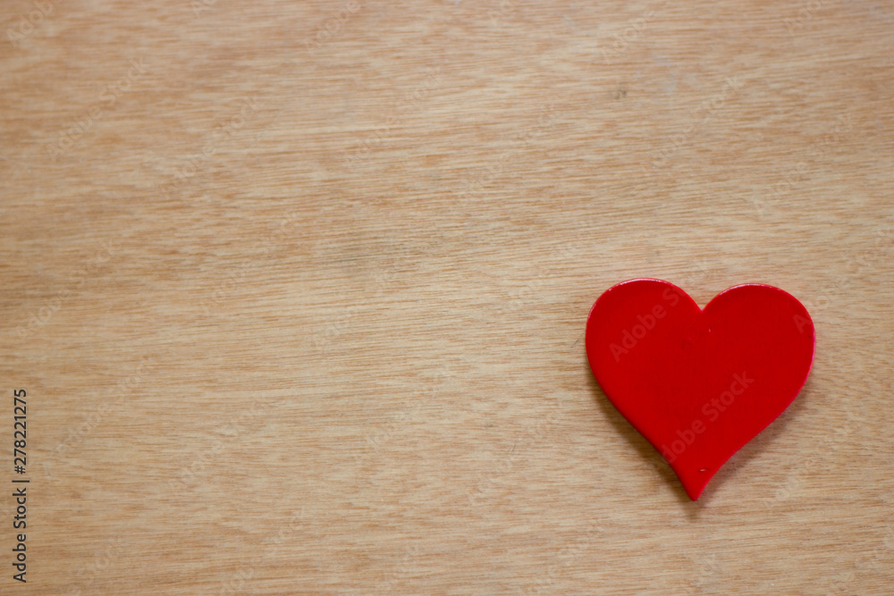 One of the red heart on the table wood One of the red heart on the table wood