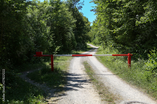 Forest road with a barrier at the entrance