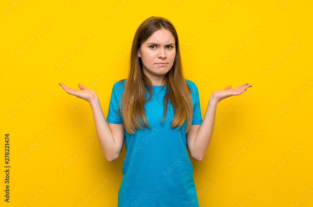 Young woman with blue shirt having doubts with confuse face expression Young woman with blue shirt having doubts with confuse face expression