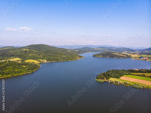 Fototapeta Naklejka Na Ścianę i Meble -  Aerial view of lake, forest and agriculture field by the water, at summer. Gruza lake near the Kragujevac in Serbia.