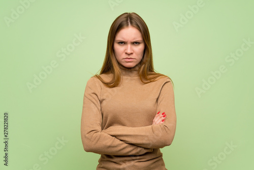Young woman with turtleneck sweater feeling upset © luismolinero