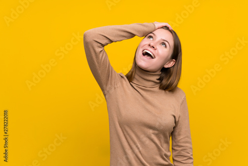 Young woman over colorful background laughing © luismolinero