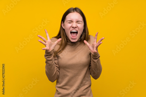 Young woman over colorful background unhappy and frustrated with something