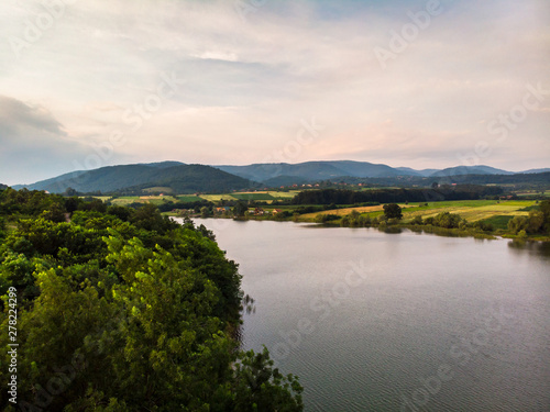 Aerial view of lake, forest and agriculture field by the water, at summer. Gruza lake near the Kragujevac in Serbia. © Milan