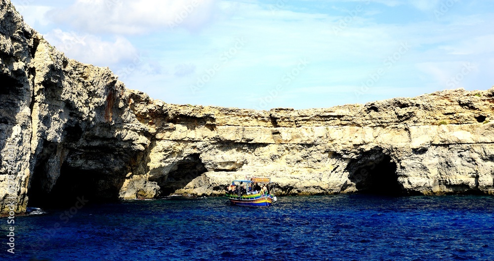 Sunlight on Smugglers Cave and cliffs Sunlight on Smugglers Cave and cliffs
