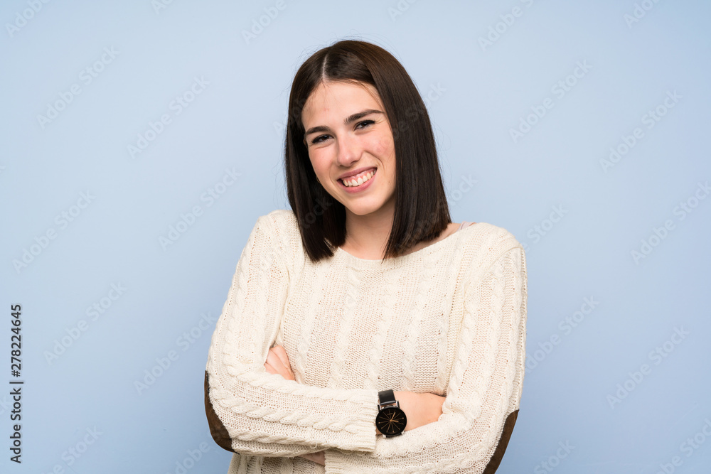 Young woman over isolated blue wall laughing Young woman over isolated blue wall laughing