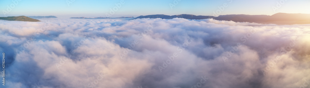 Obraz premium Aerial view white clouds in blue sky at morning.