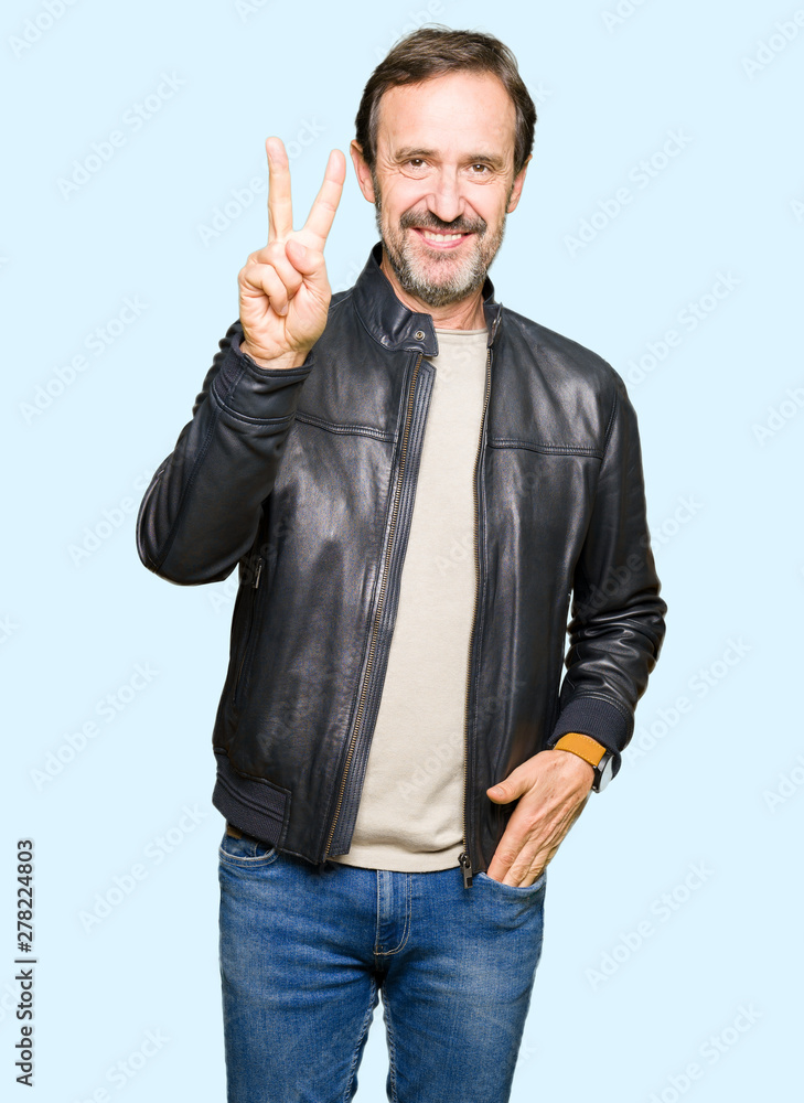 Middle age handsome man wearing black leather jacket showing and pointing up with fingers number two while smiling confident and happy. Middle age handsome man wearing black leather jacket showing and pointing up with fingers number two while smiling confident and happy.