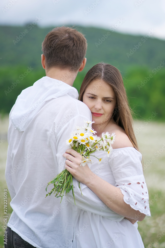 Happy couple on camomile meadow. Happy couple on camomile meadow.