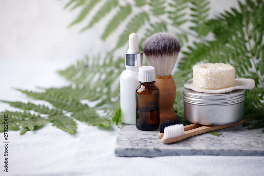 different eco friendly cosmetic products in bathroom. Minimizing ecological footprint concept. Bamboo bath towel, biodegradable bamboo toothbrush, aroma oil