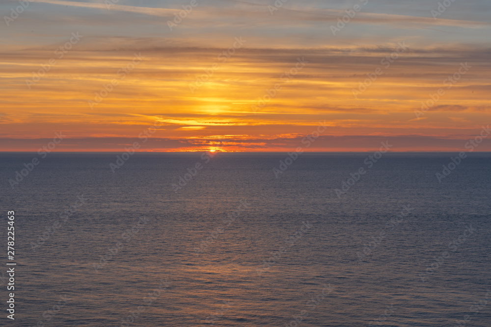 Fototapeta premium Etretat, France - 05 31 2019: sunset over the sea of Etretat