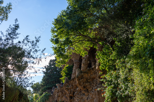 Parc Guell, detail of Portico della Lavandaia, surrounded by wild nature. Barcelona.