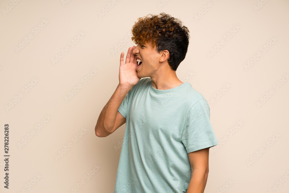 African american man with green shirt shouting with mouth wide open to the lateral African american man with green shirt shouting with mouth wide open to the lateral