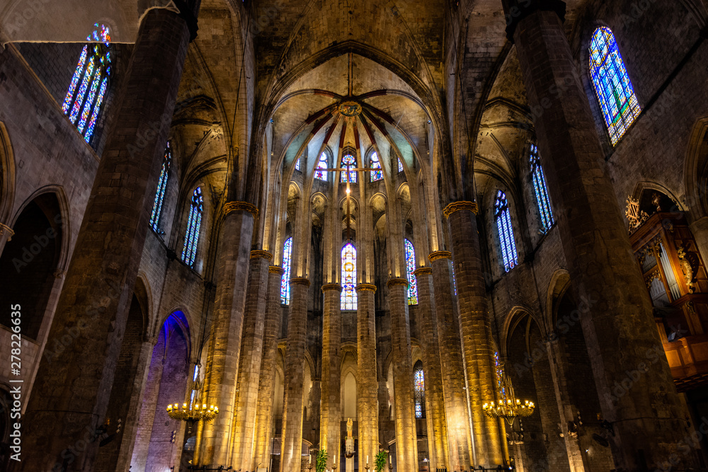 Interior of Santa Maria del Mar Basilica in typical Catalan Gothic style with pointed arches, high columns and colourful windows. La Ribera. Barcelona.