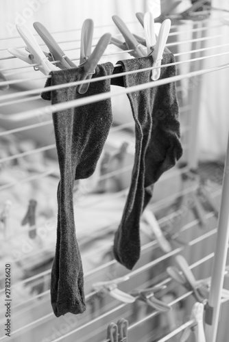 Drying socks are hanging on the clothes dryer with clothespin, black and whyte creative, concept photo photo