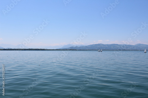 Sailors on Lake Constance  in the background the Alps
