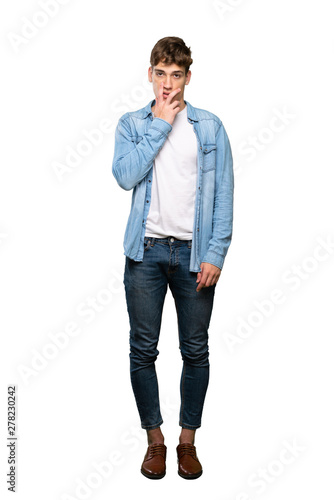 A full-length shot of a Handsome young man surprised and shocked while looking right over isolated white background