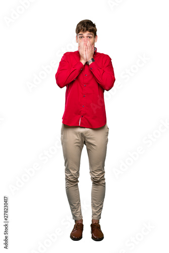 A full-length shot of a Handsome young man with surprise facial expression over isolated white background