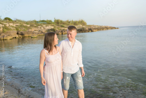 Happy Romantic Middle Aged Couple Enjoying Beautiful Sunset Walk on the Beach. Travel Vacation Retirement Lifestyle Concept © Konstantin Maslak