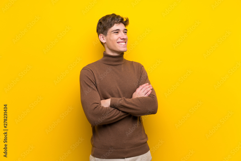 Handsome young man over isolated yellow background happy and smiling Handsome young man over isolated yellow background happy and smiling