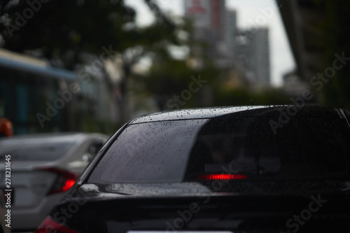 Fototapeta Naklejka Na Ścianę i Meble -  Rain drops on rear car mirror shield