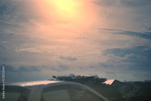 Fototapeta Naklejka Na Ścianę i Meble -  Car roof outside in sun set sky clouds background