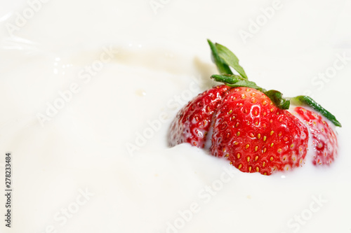 juicy strawberries in milk, falling strawberries
