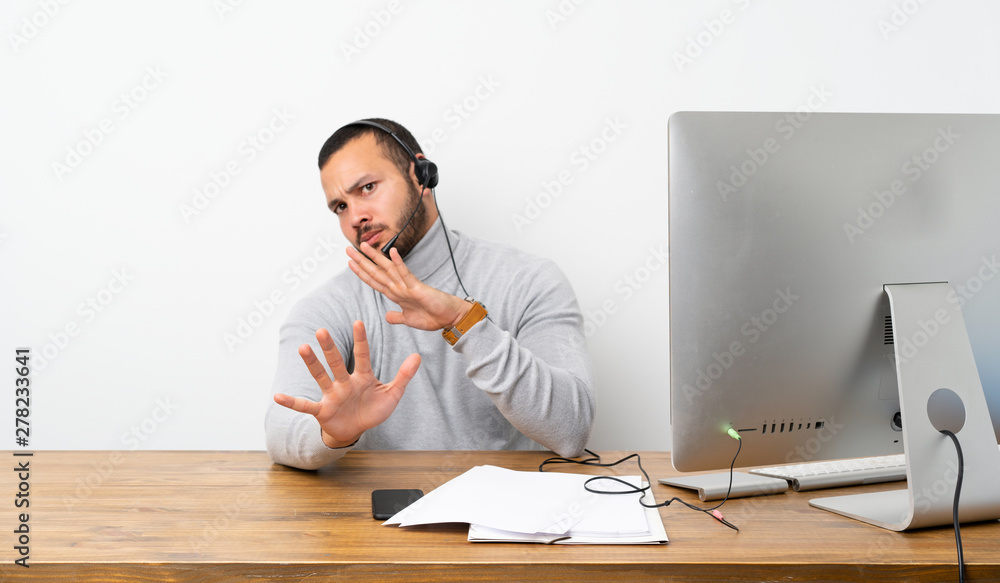 Telemarketer Colombian man nervous stretching hands to the front