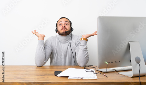 Obraz na płótnie Telemarketer Colombian man having doubts while raising hands