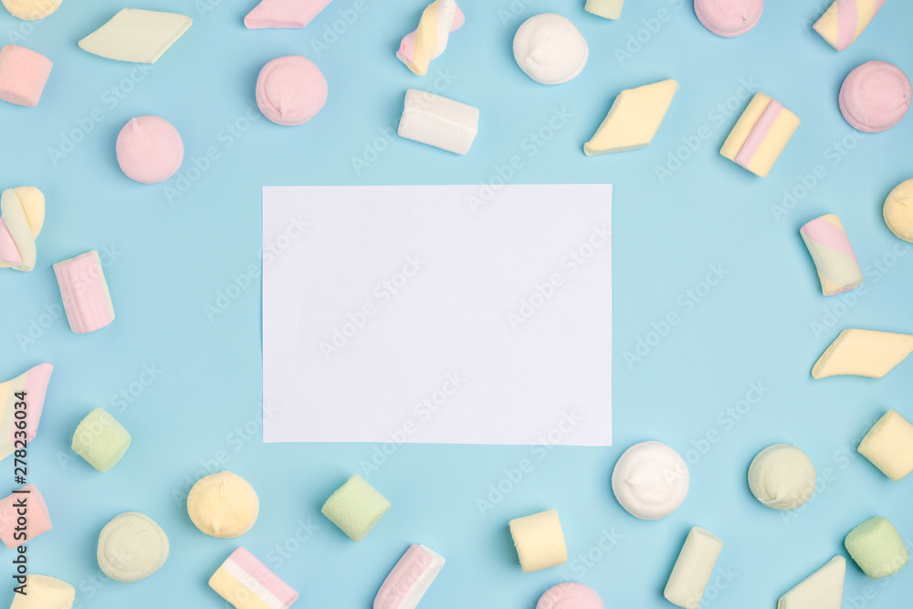 Blue paper background with marshmallow and notepad. Place for your text. Cozy sweet background Blue paper background with marshmallow and notepad. Place for your text. Cozy sweet background