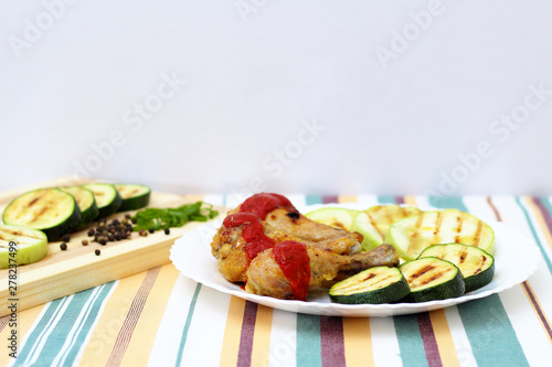grilled chicken, zucchini and lemon, bright background, side view