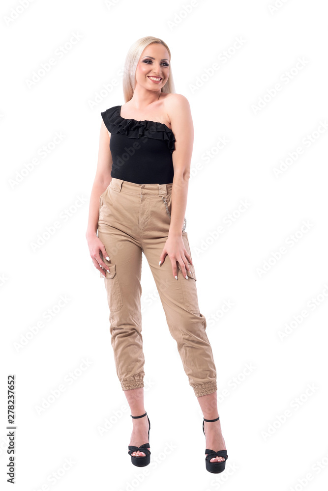 Happy sexy young blond hair woman in creme pants and off shoulder top posing. Full body isolated on white background. Happy sexy young blond hair woman in creme pants and off shoulder top posing. Full body isolated on white background.