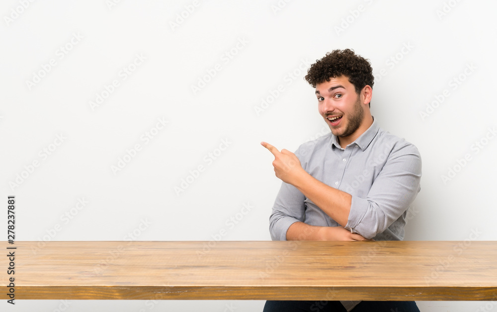 Fototapeta premium Young man with a table pointing back