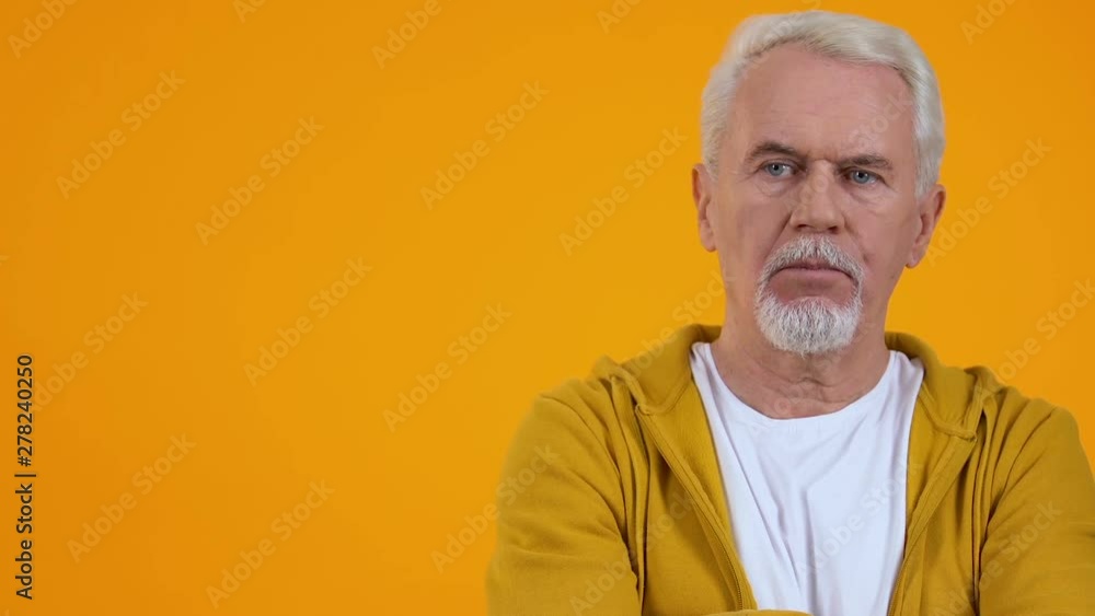 Displeased retired man on bright background, condemnation expression, accusation Displeased retired man on bright background, condemnation expression, accusation