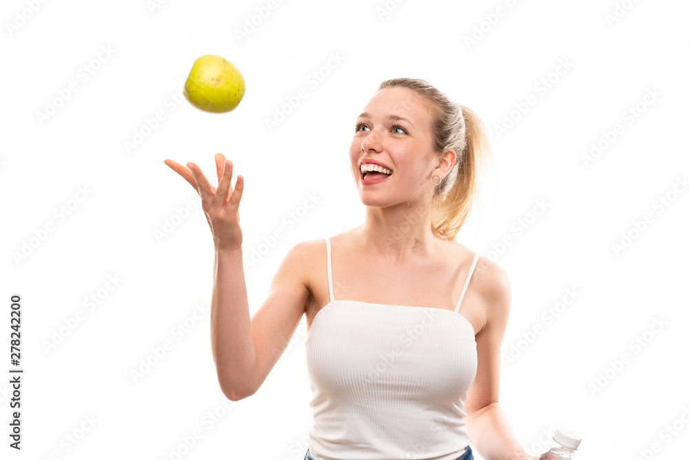Young blonde woman over isolated white background with an apple Young blonde woman over isolated white background with an apple