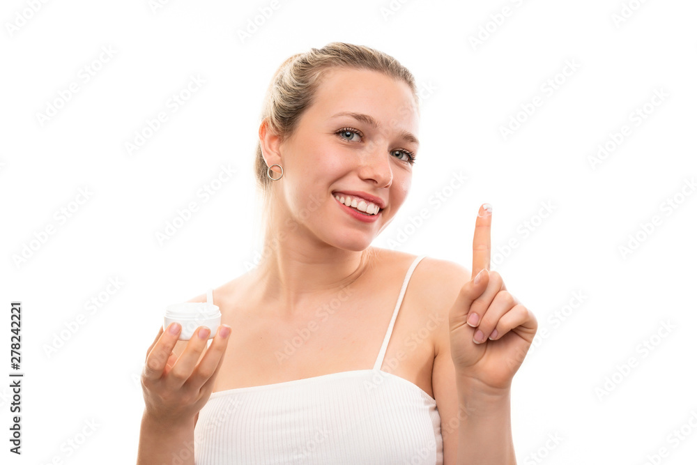 Young blonde woman over isolated white background with moisturizer Young blonde woman over isolated white background with moisturizer