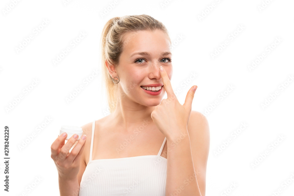 Young blonde woman over isolated white background with moisturizer Young blonde woman over isolated white background with moisturizer