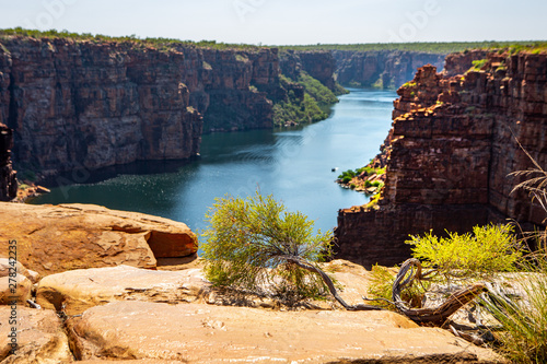high angel view over King George River Gorge and plateau in the Kimberleys  with lush bushes and sandstone formation in  the foreground and background