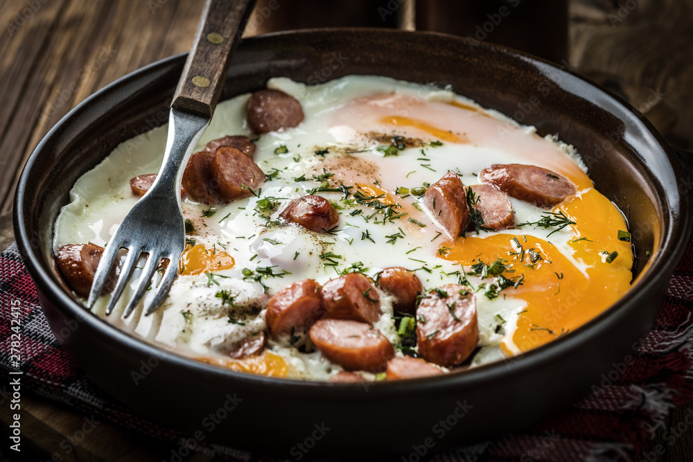 Tasty cooked egg with chopped sausages. Tasty cooked egg with chopped sausages.